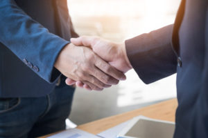 Two confident business man shaking hands during a meeting in the